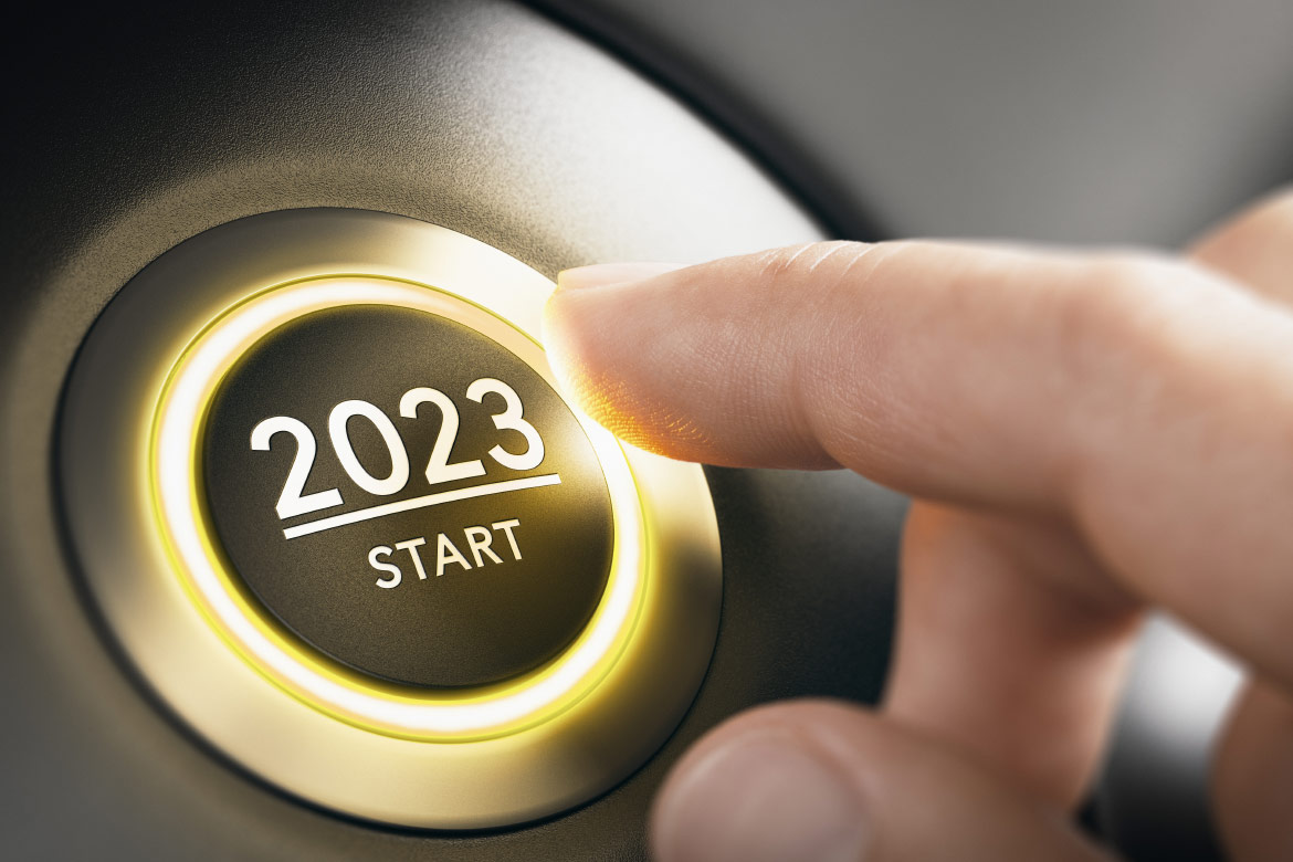 A vehicle ignition start button with the year 2023 written on it. 