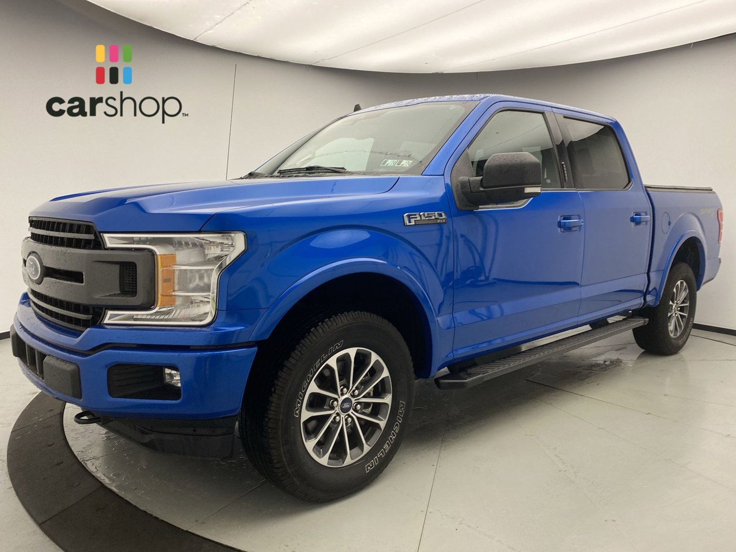 A blue Ford F–150 used vehicle.